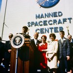 President John F. Kennedy stands at a podium in front of the Manned Spacecraft Center to honor astronaut John Glenn, Jr.