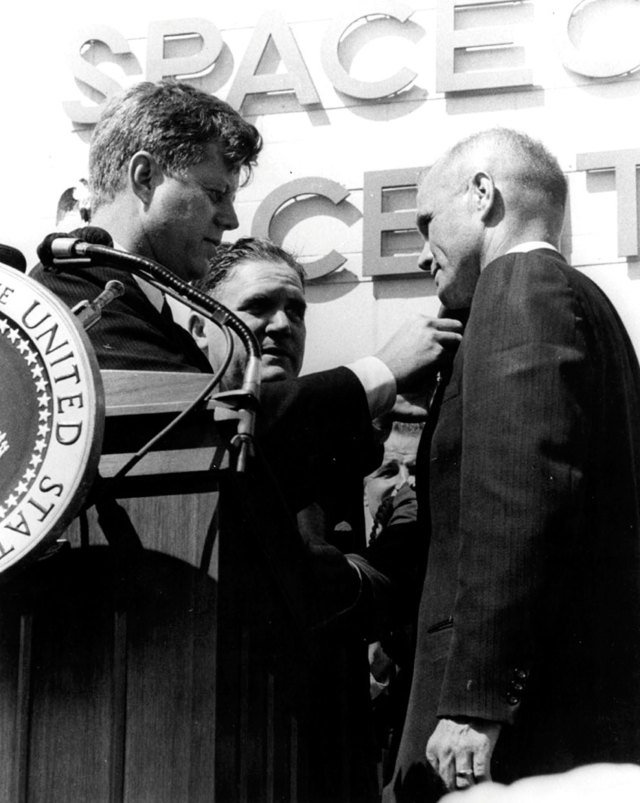 President John F. Kennedy pins a NASA Distinguished Service Medal on astronaut John Glenn Jr. at the Manned Spacecraft Center.