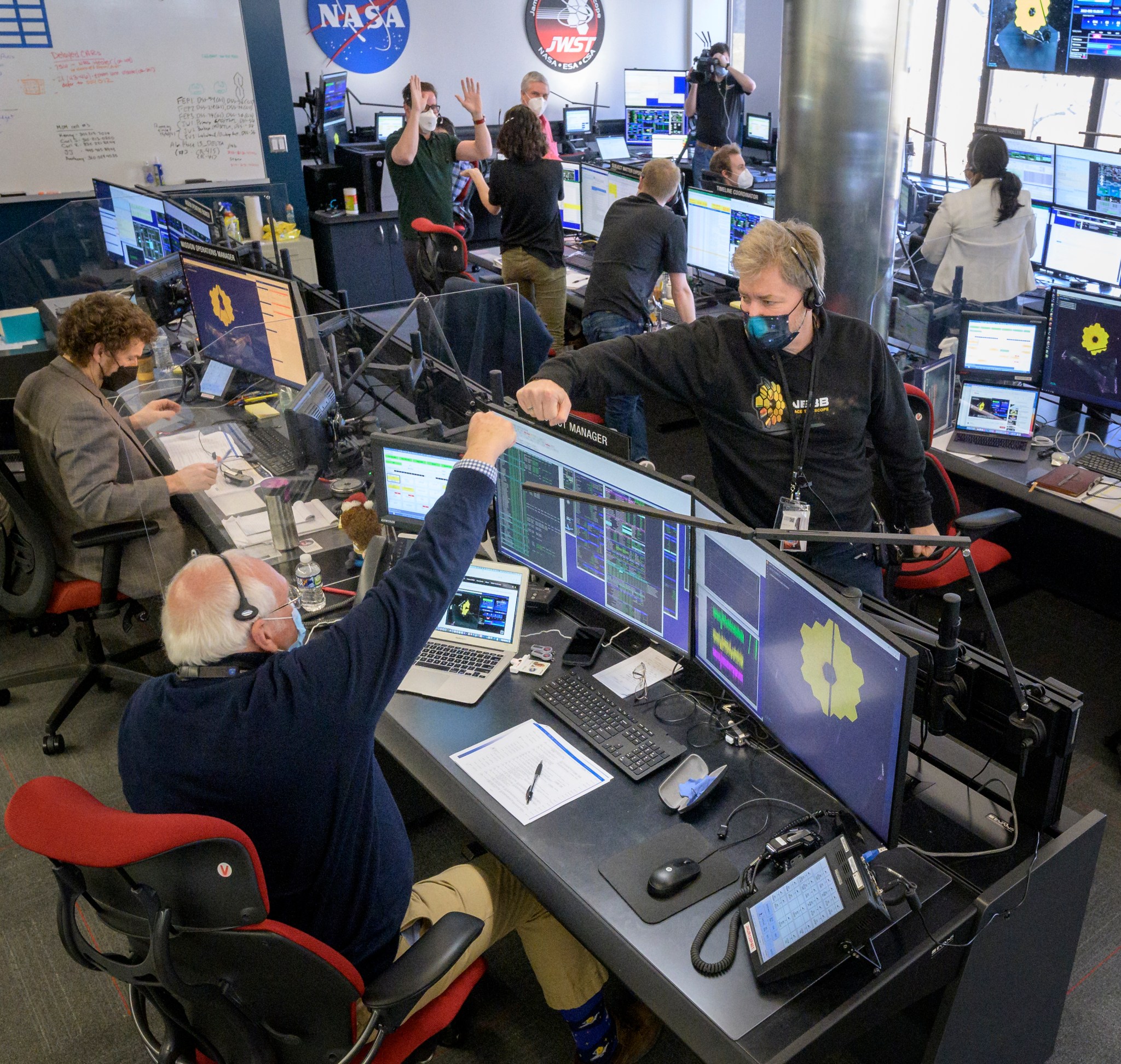 Engineers celebrating in Mission Operations Center