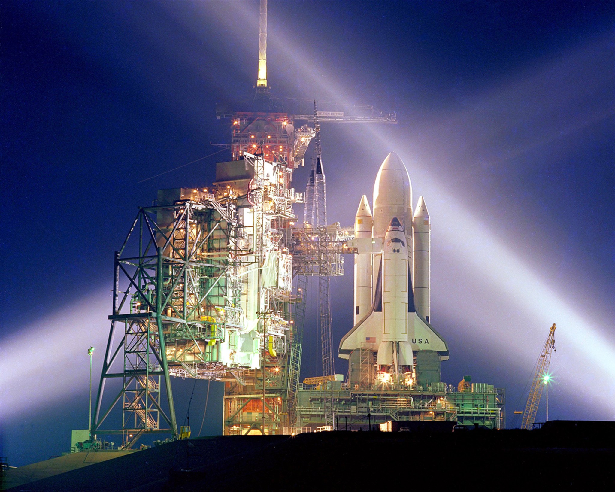 Spotlights shine on Space Shuttle Columbia as it sits on the launch pad prior to its first flight.