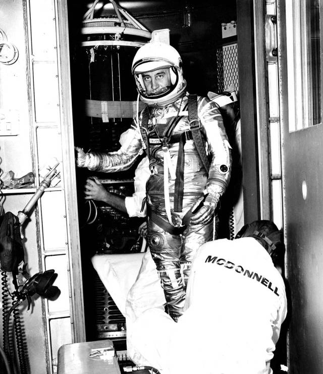 Project Mercury astronaut Gus Grissom is assisted by McDonnell technicians as he leaves the Liberty Bell 7 Mercury spacecraft.