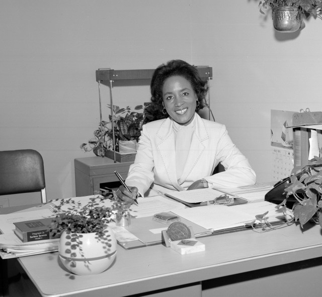 Annie Easley sits at a desk in her office in 1981
