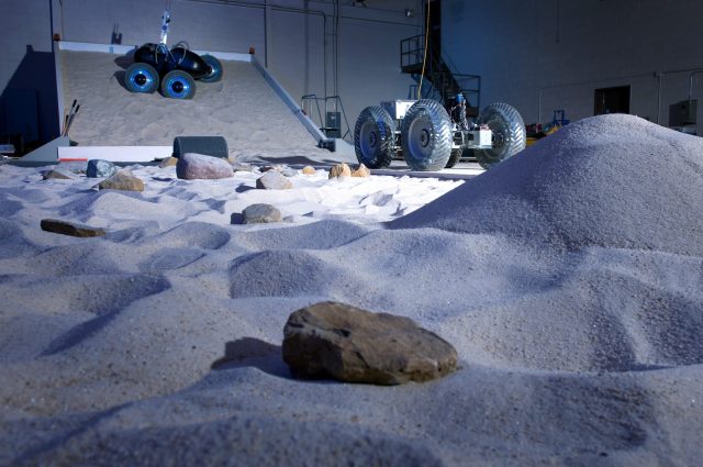 two vehicles in slope lab with blue lighting for dramatic effect