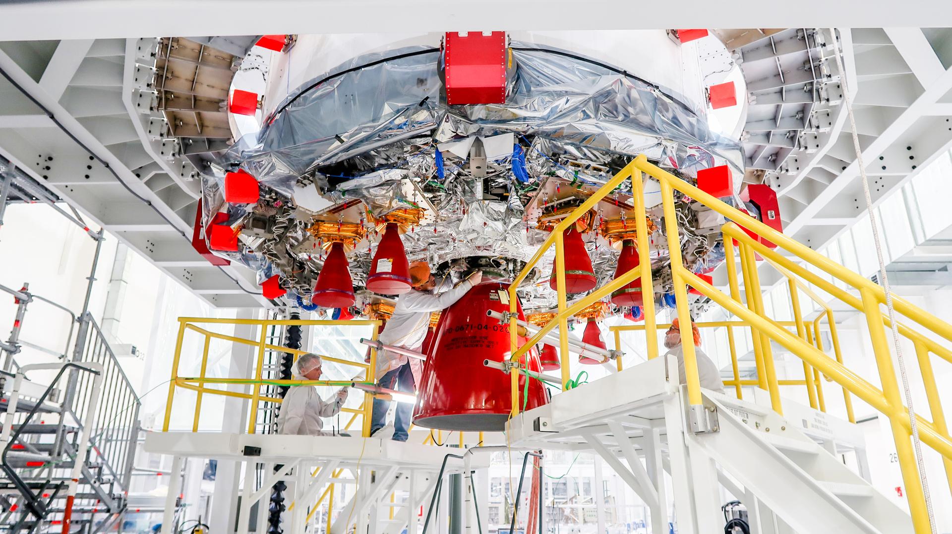 Technicians at NASA’s Kennedy Space Center in Florida finish installing the orbital maneuvering system engine nozzle and heat shield for the Artemis II European Service Module inside the Ou0026amp;C Building on Jan. 16, 2023. 