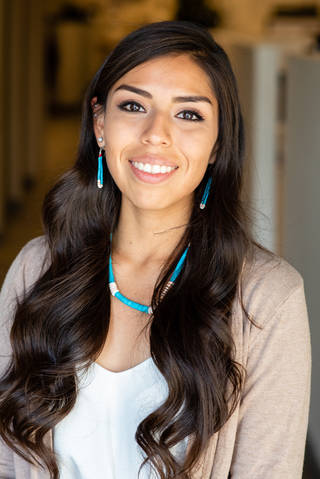 Female smiling in front of camera.