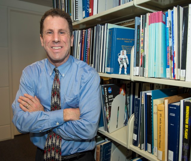 Historian Stephen Garber poses in the NASA Headquarters library