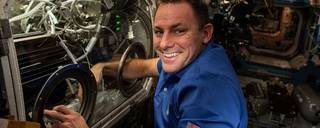 Josh Cassada swaps samples for PFMI-Ascent, which demonstrates a passive cooling system for electronic devices in microgravity using a micro-structured surface.