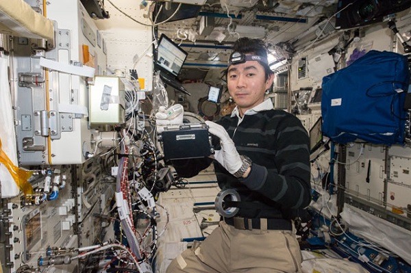 image of an astronaut working with an experiment