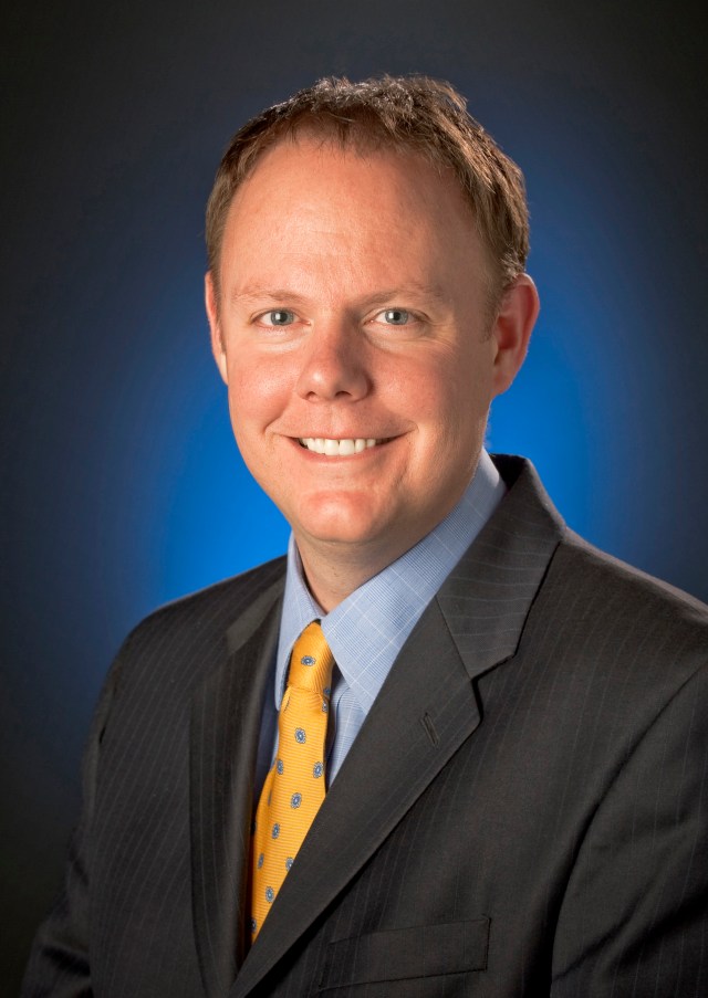 Jon Montgomery, wearing a suit and a yellow tie. 