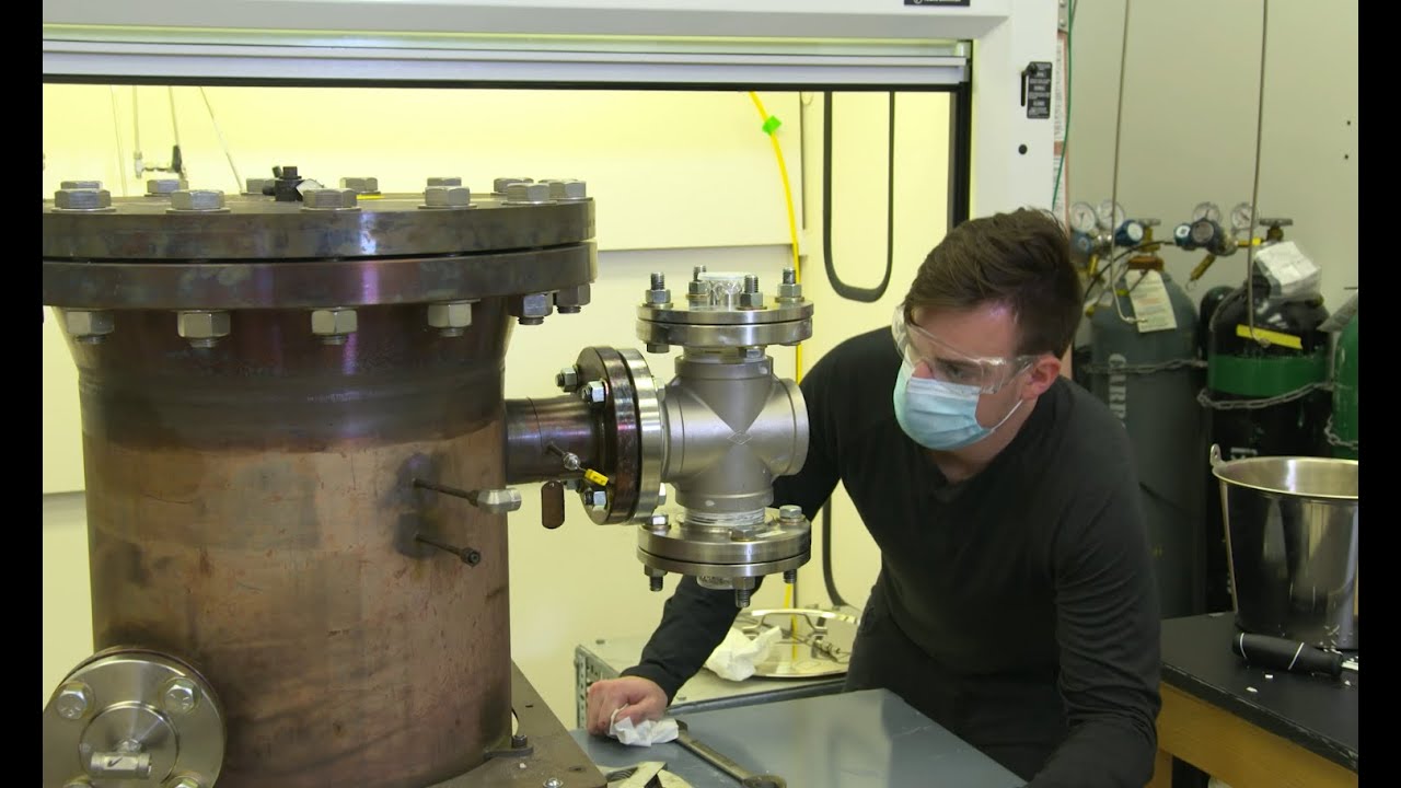 Kevin Grossman looks at a piece of equipment