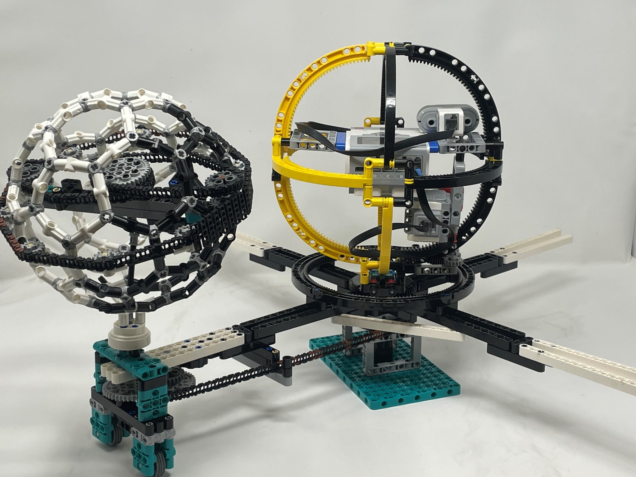 The lunar solar farm model built by the Lykos Robotics team features a yellow and black sphere representing the Earth, with the yellow side as the side facing the Sun and the black side as the side in shadow. 