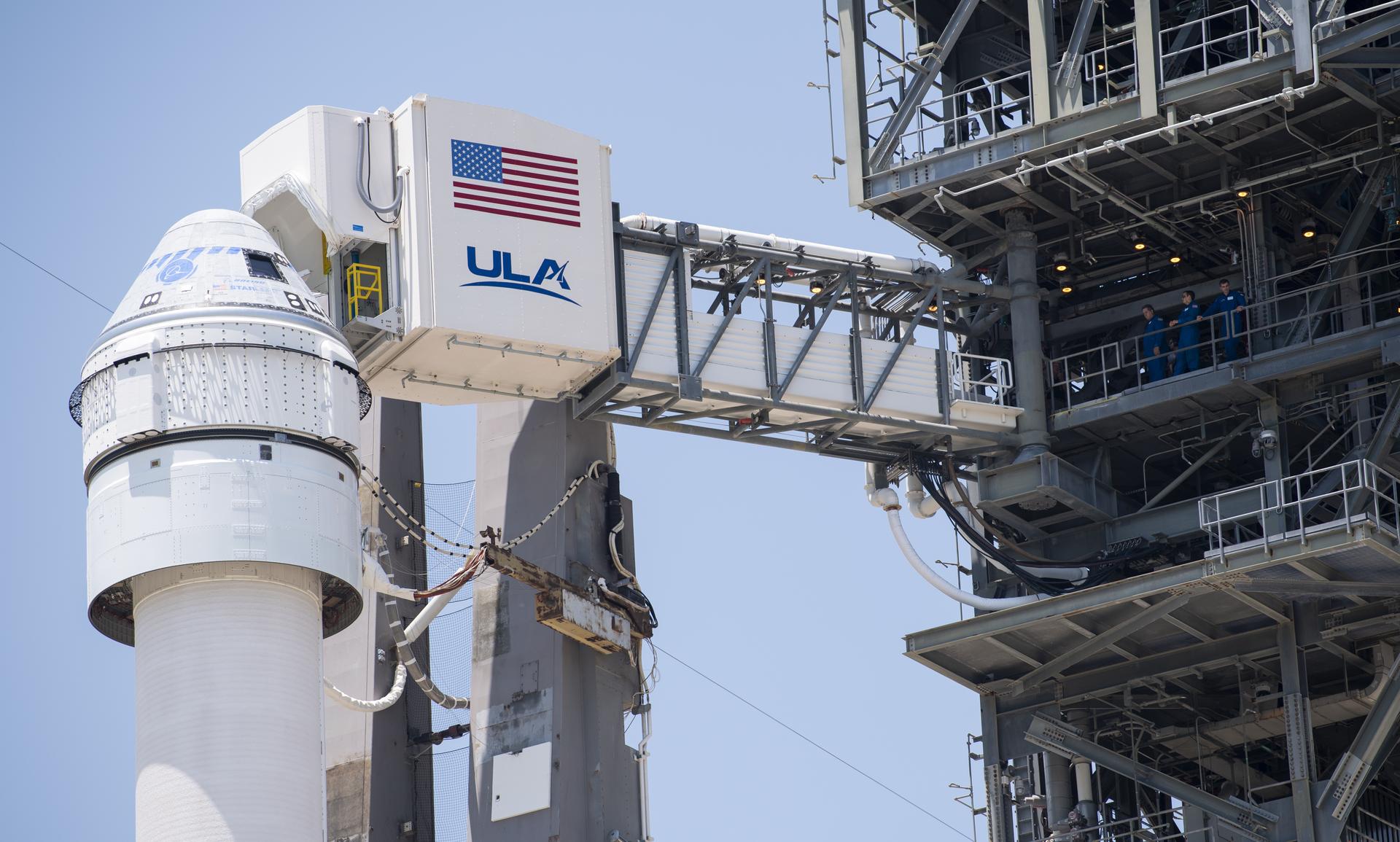 The crew access arm is seen as it swings into position for Boeing’s CST-100 Starliner spacecraft atop a United Launch Alliance Atlas V rocket at the launch pad at Space Launch Complex 41 ahead of the Orbital Flight Test-2 mission.