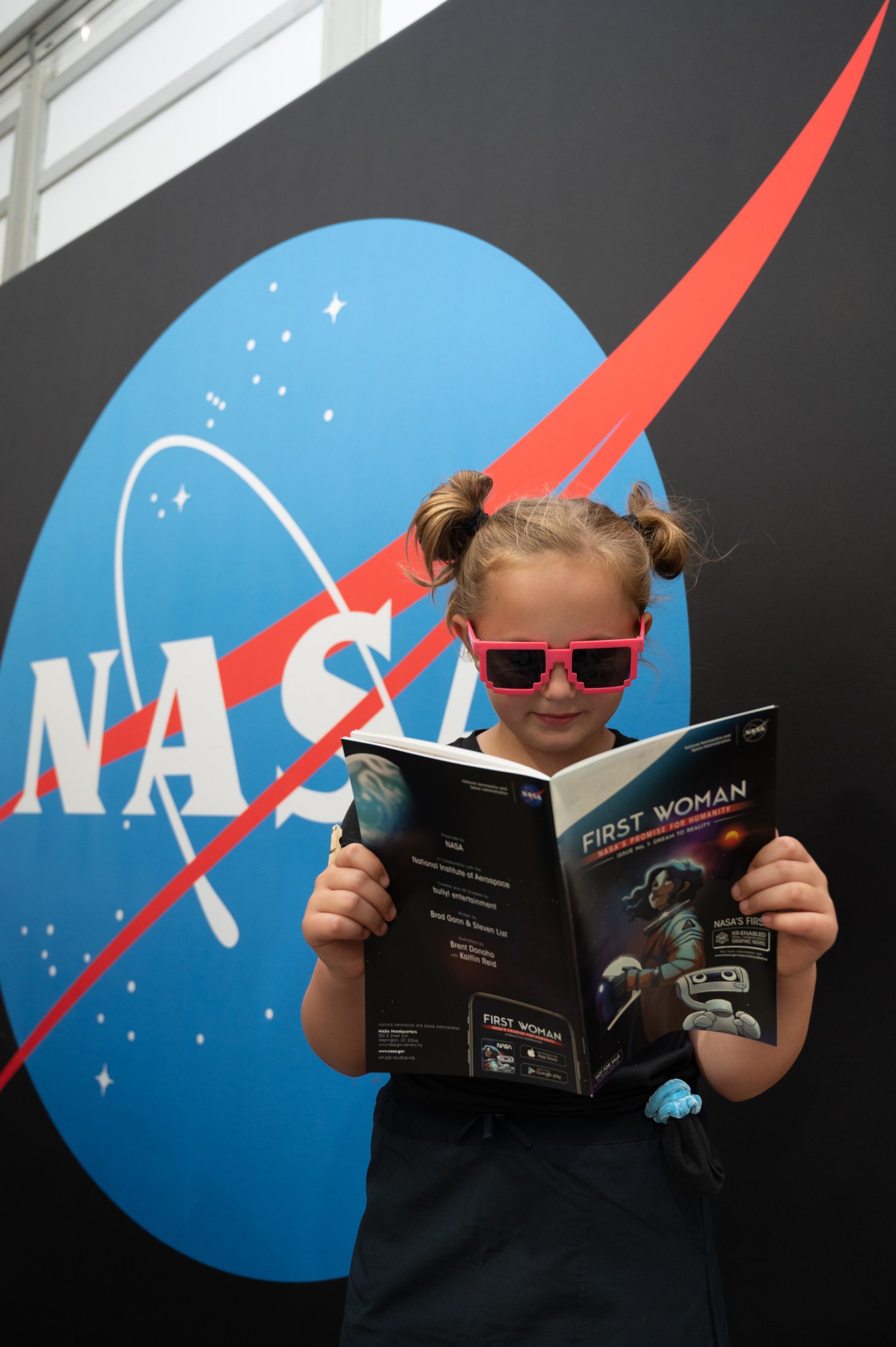 Young girl reading First Woman Astronaut graphic novel