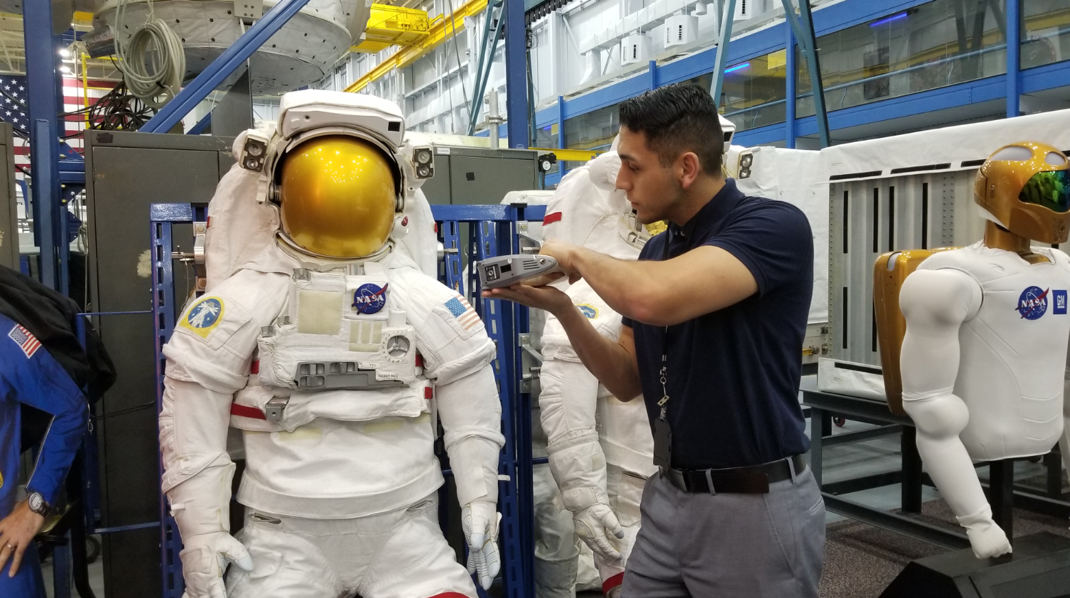 An intern working on a space suit