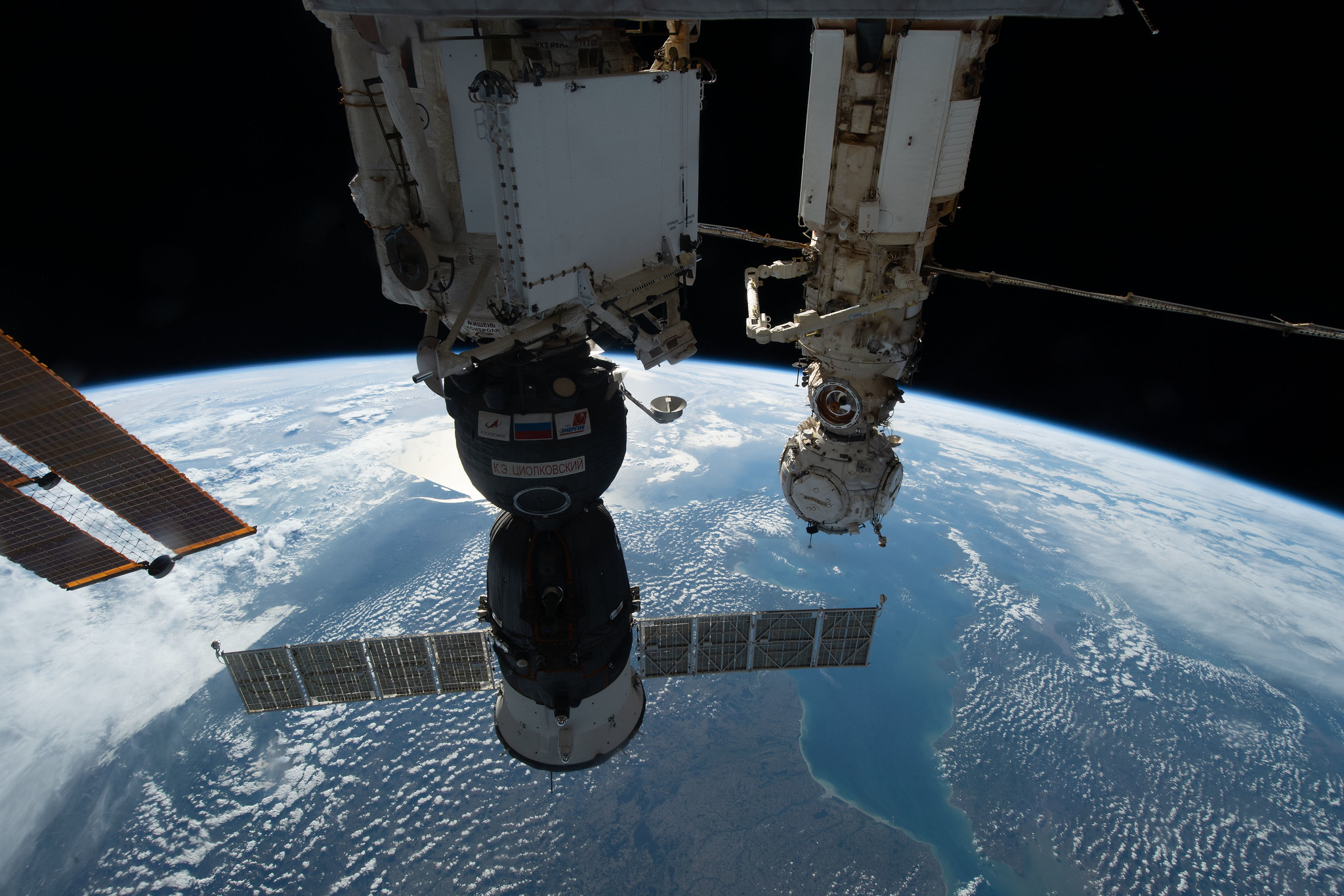The Soyuz MS-22 crew ship is docked to the International Space Station with the Earth in the background.