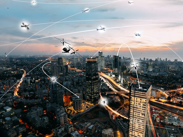 An artist’s conception of an urban air mobility environment with various unmanned aircraft within a city.