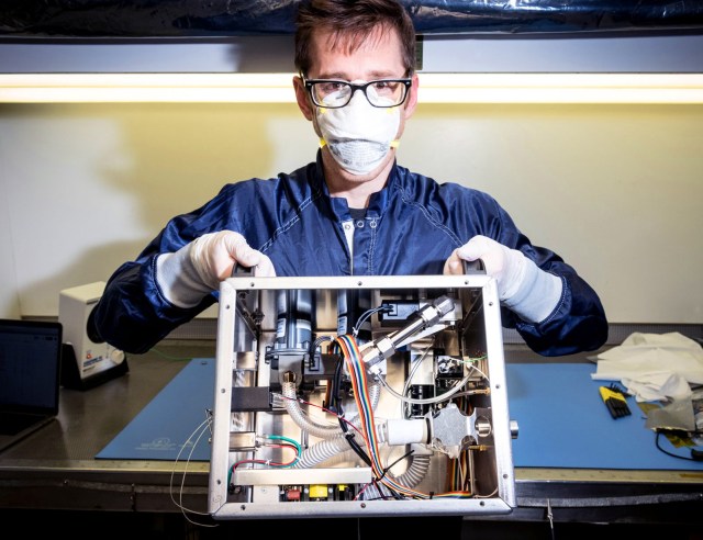 JPL engineer Patrick Degrosse shows the inside of VITAL, a type of ventilator.