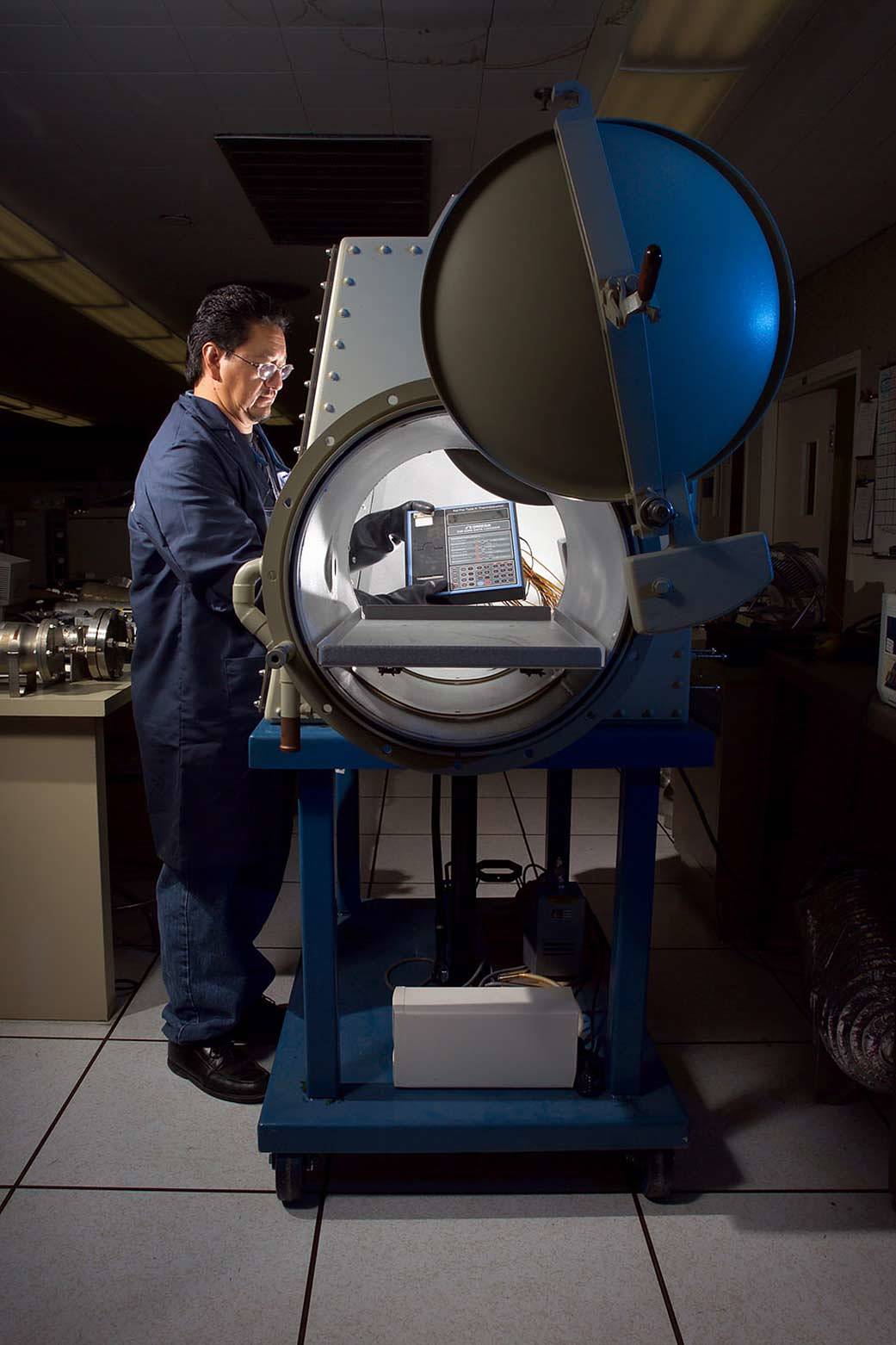 A man stands by a piece of equipment