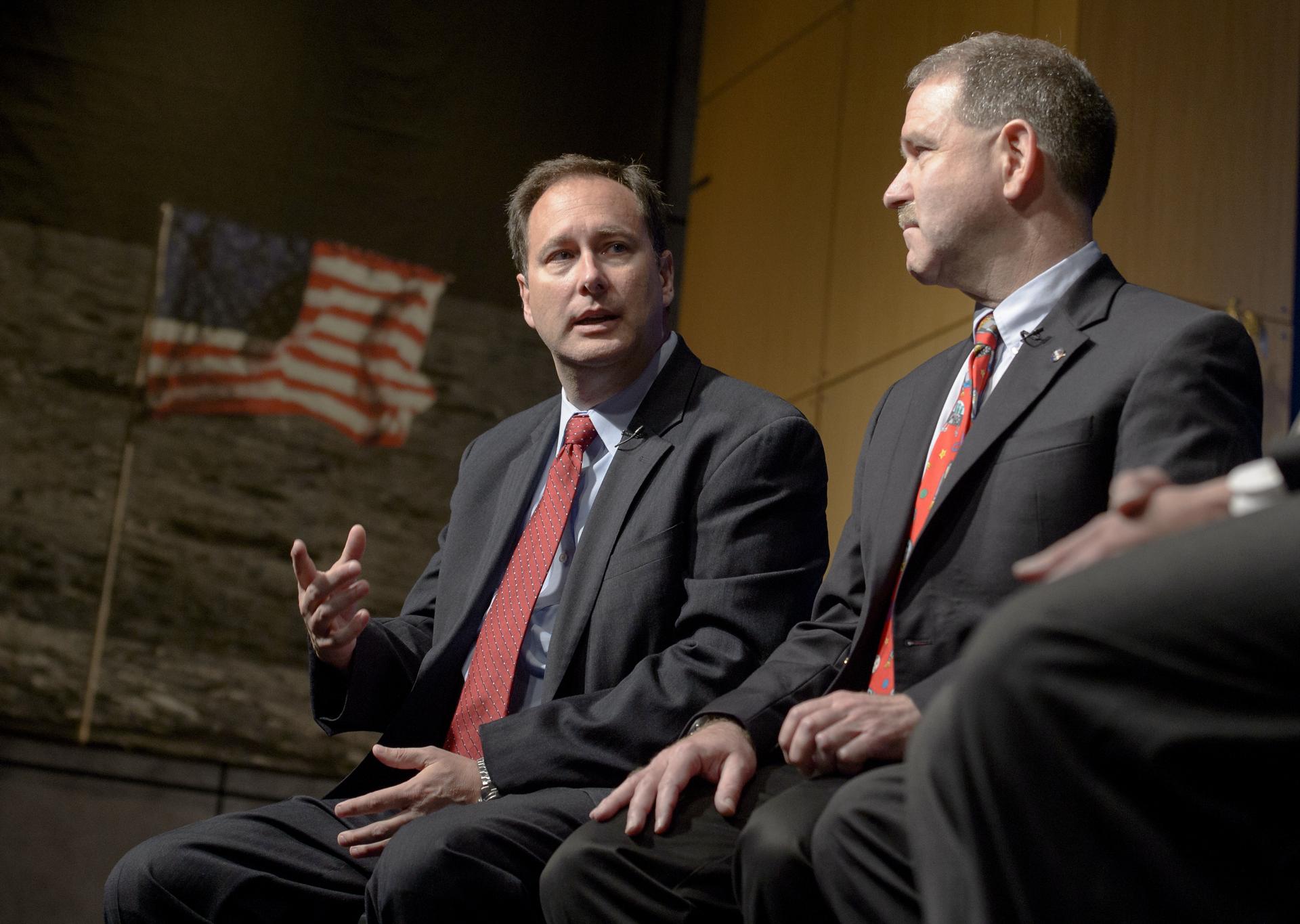 Robert Lightfoot (left) speaks at an event at NASA Headquarters