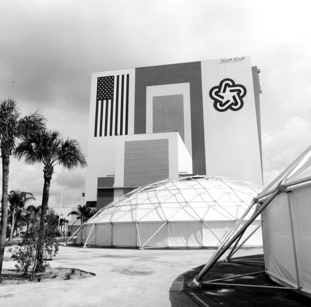 View of the Vehicle Assembly Building with the domes set up for the Third Century America exposition in the foreground.