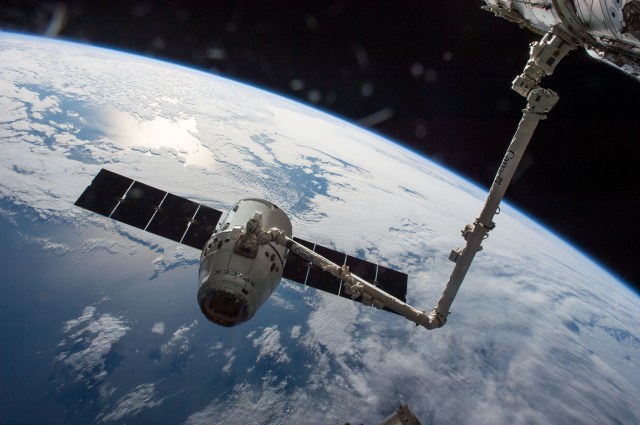 The SpaceX Dragon cargo spaceship is grappled by the International Space Station's Canadarm2.