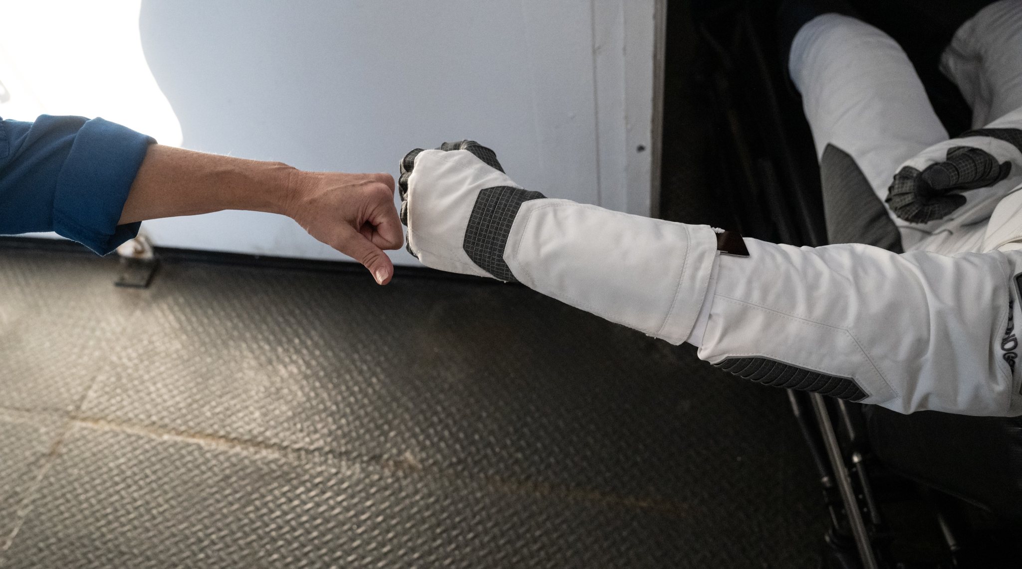 NASA astronaut representative Megan Behnken, left, fist bumps NASA astronaut Kjell Lindgren after having splashed down in the Atlantic Ocean off the coast of Jacksonville, Florida aboard the SpaceX Crew Dragon Freedom spacecraft.