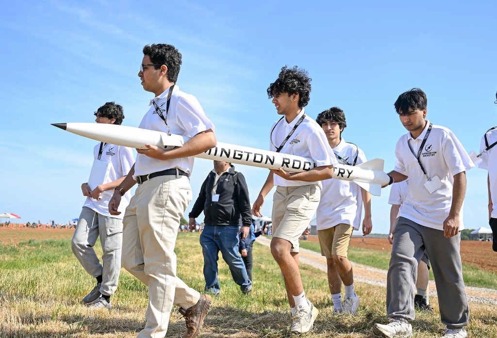 A group of students carry their rocket during the 2026 Student Launch Challenge