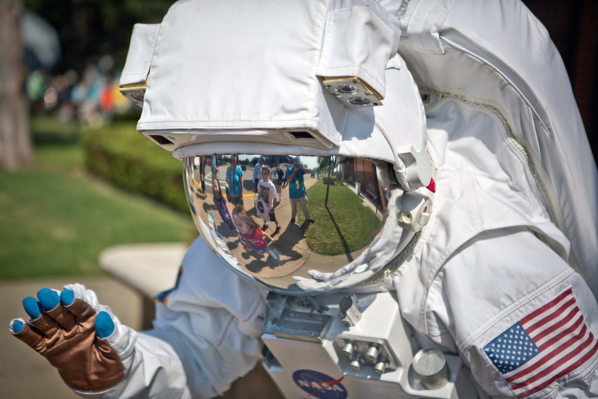 A NASA Langley Research Center employee in a space suit greets NASA fans.