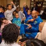 Former NASA Astronaut, Leland Melvin, talks to school children during an Science, Technology, Engineering, and Math (STEM) education event.