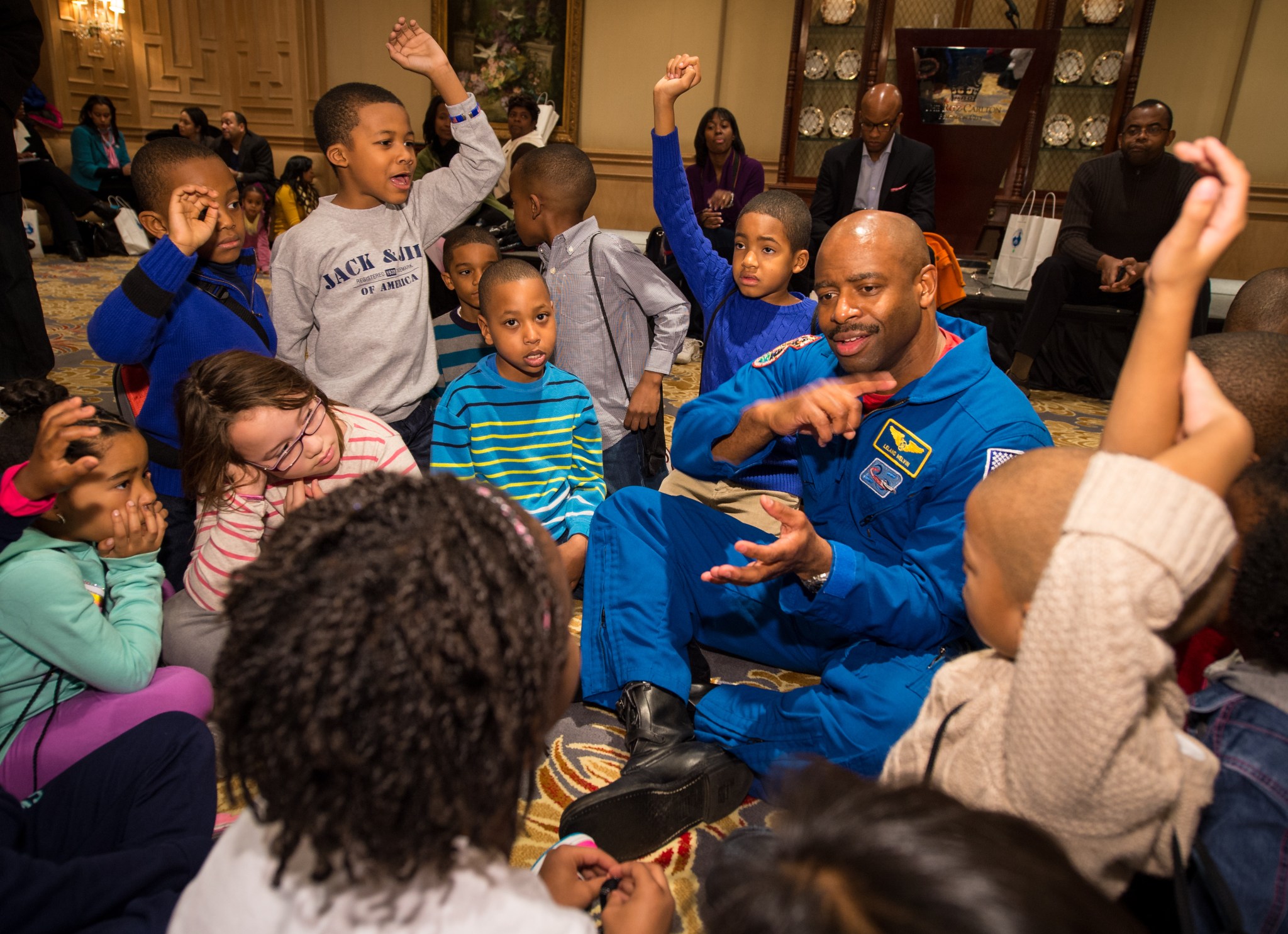 Former NASA Astronaut, Leland Melvin, talks to school children during an Science, Technology, Engineering, and Math (STEM) education event.
