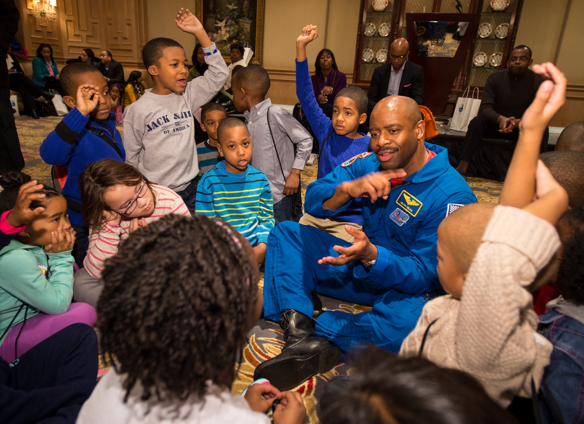 Former NASA Astronaut, Leland Melvin, talks to school children during an Science, Technology, Engineering, and Math (STEM) education event outside the classroom