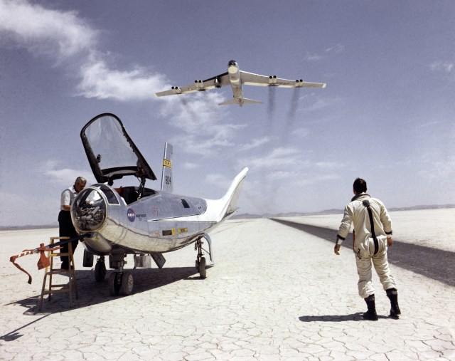 NASA research pilot Bill Dana takes a moment to watch NASA's NB-52B cruise overhead after a research flight in the HL-10.