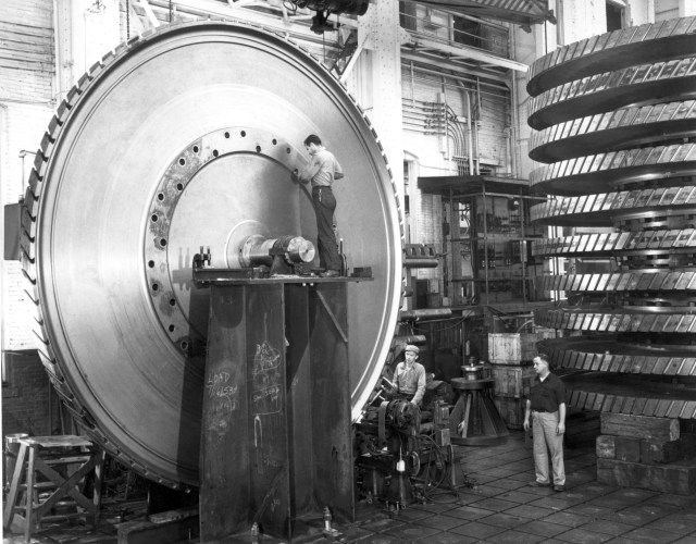 men working on 3-stage compressor