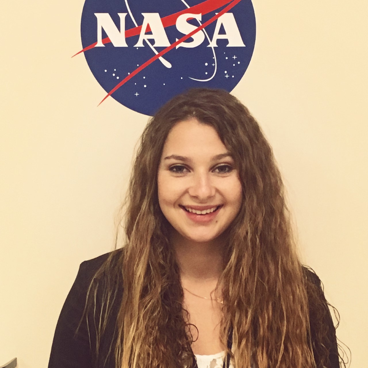 Headshot of Kassidy Mclaughlin with NASA logo.