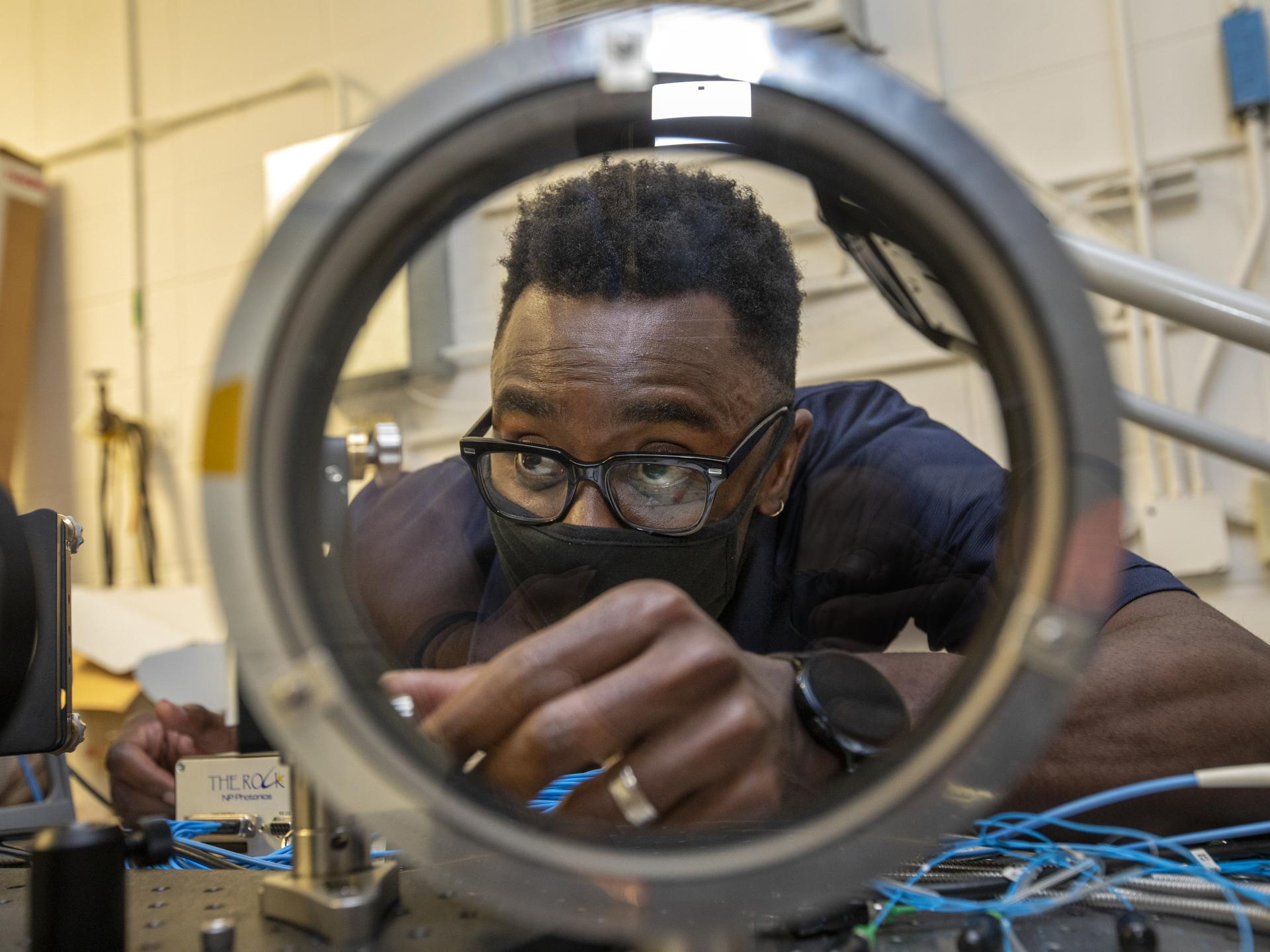 Engineer looks through a directional optics glass.