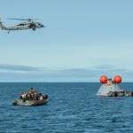 NASA's Landing and Recovery Team practices bringing a mock Orion capsule into the well deck of the USS Portland (LPD 27) ahead of the Artemis I Orion splashdown.