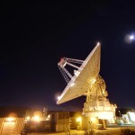 Goldstone's 230-foot (70-meter) antenna set against a dark sky