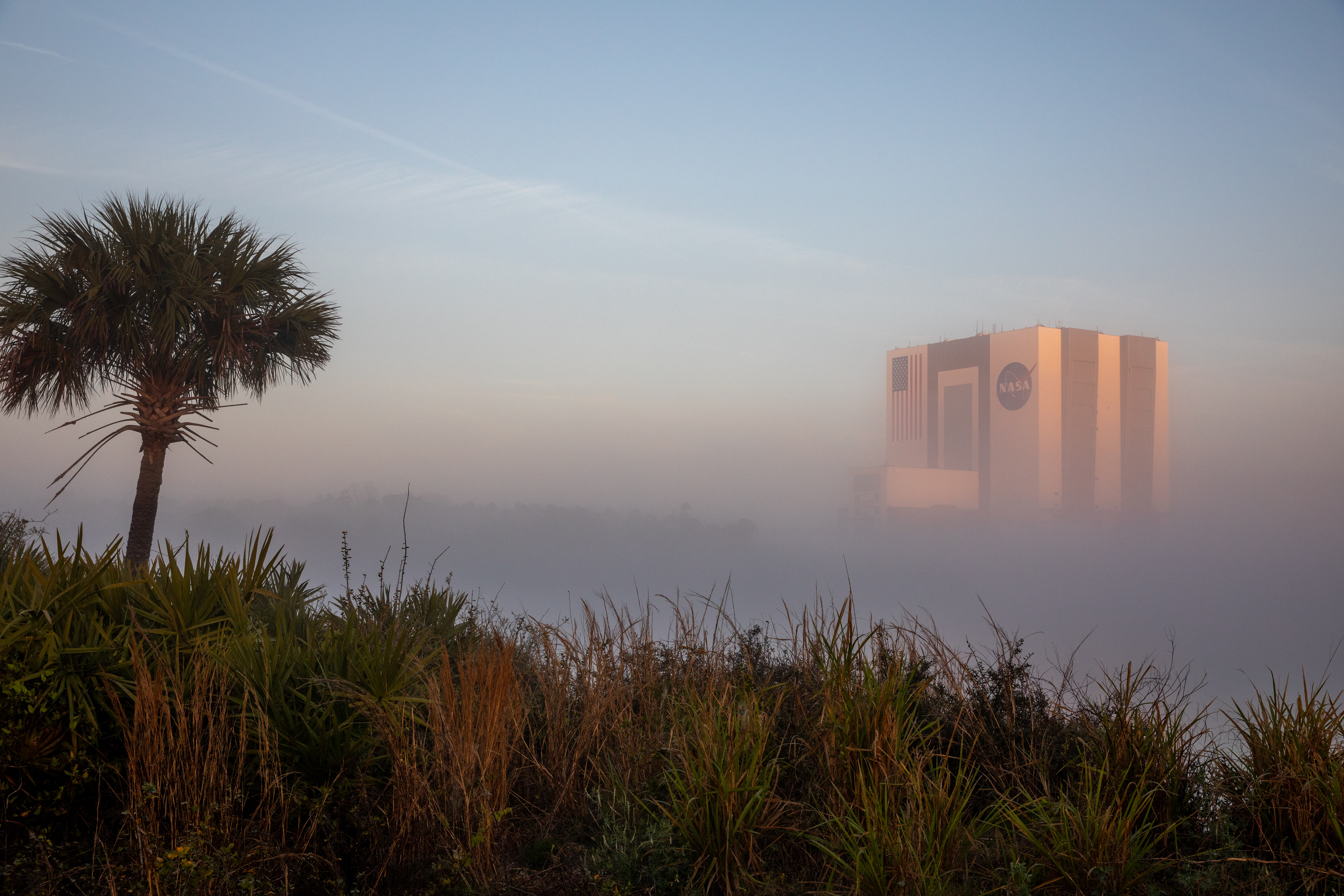 The top of the Vehicle Assembly Building visible above some fog at NASA's Kennedy Space Center in Florida.
