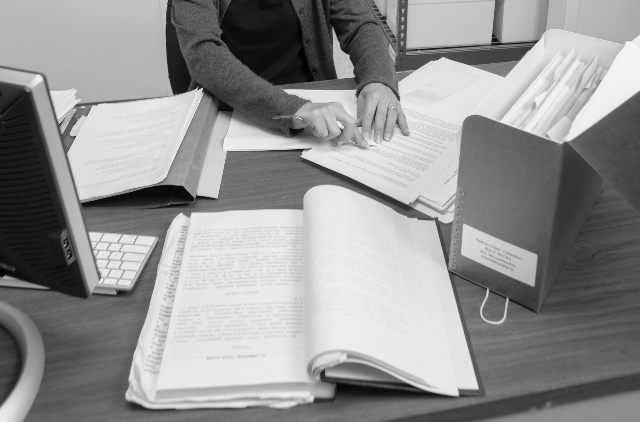 Photograph showing archival documents and the hands of Ames Senior Archivist April Gage as she works to preserve them.