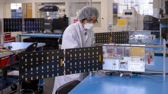 engineer with a starling cubesat in lab
