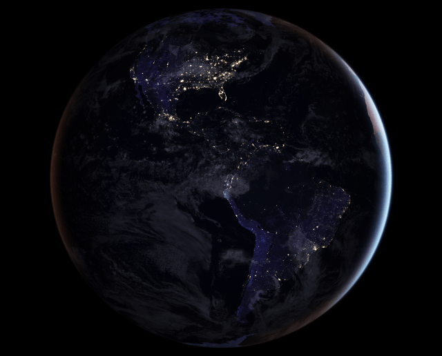 This is a photo of North America at night. Light from cities shines in the dark.