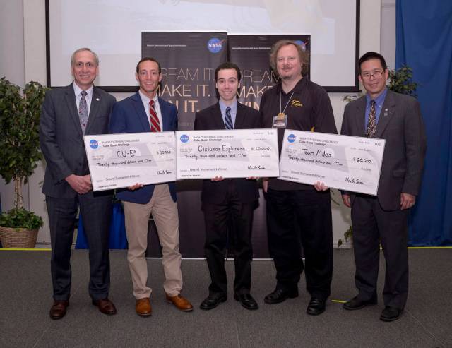 Five men hold three giant checks for the CubeSat Challenges
