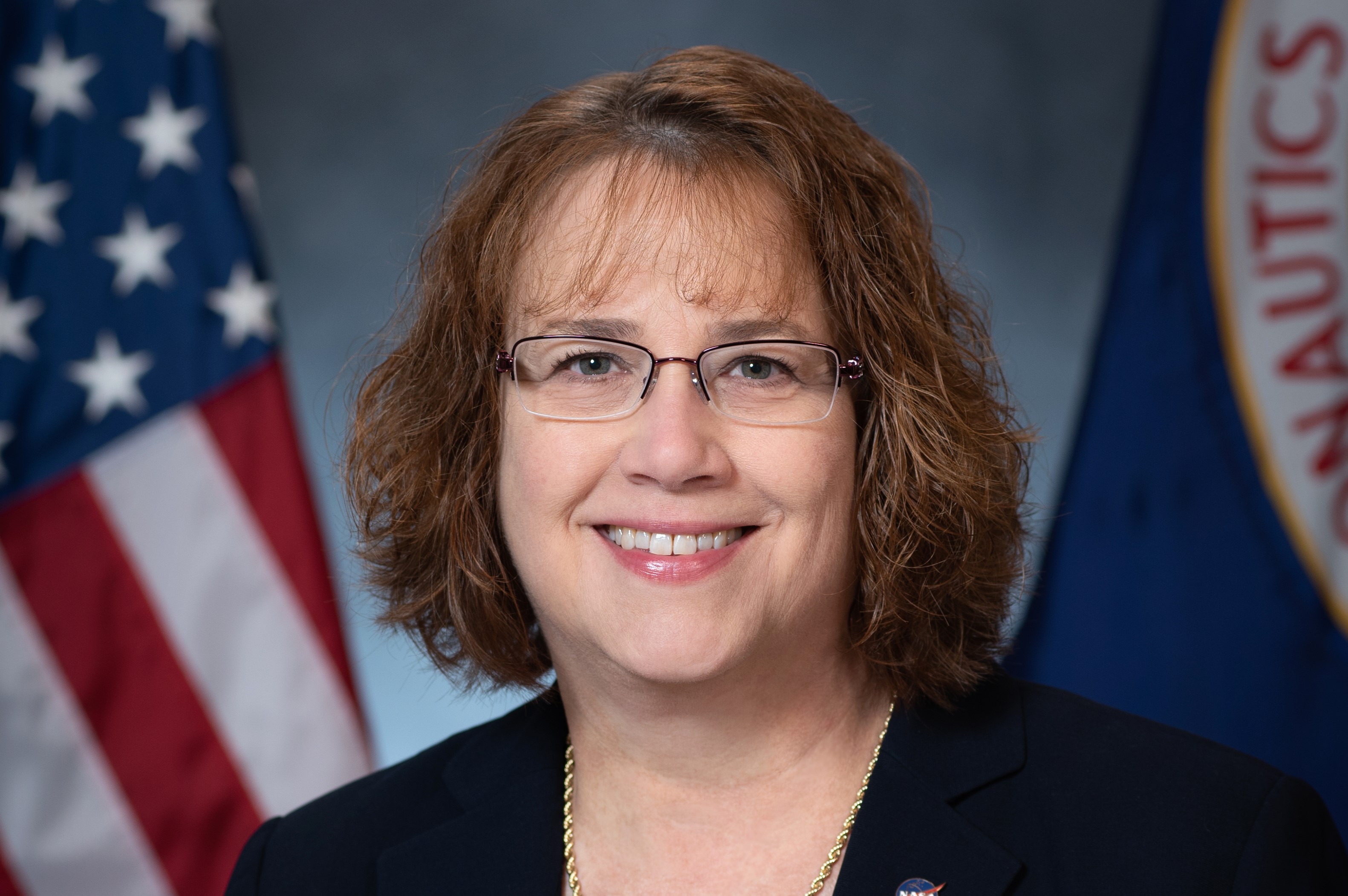 Dawn Schaible poses in front of the American Flag.