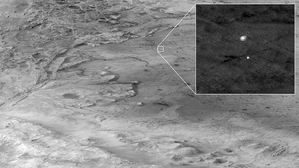 A black and white landscape taken from high altitudes looking down, a small square zooms into the descent stage holding NASAs Perseverance rover