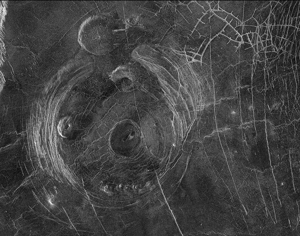 This radar image from NASA’s Magellan mission shows circular fracture patterns surrounding the “Aine” corona