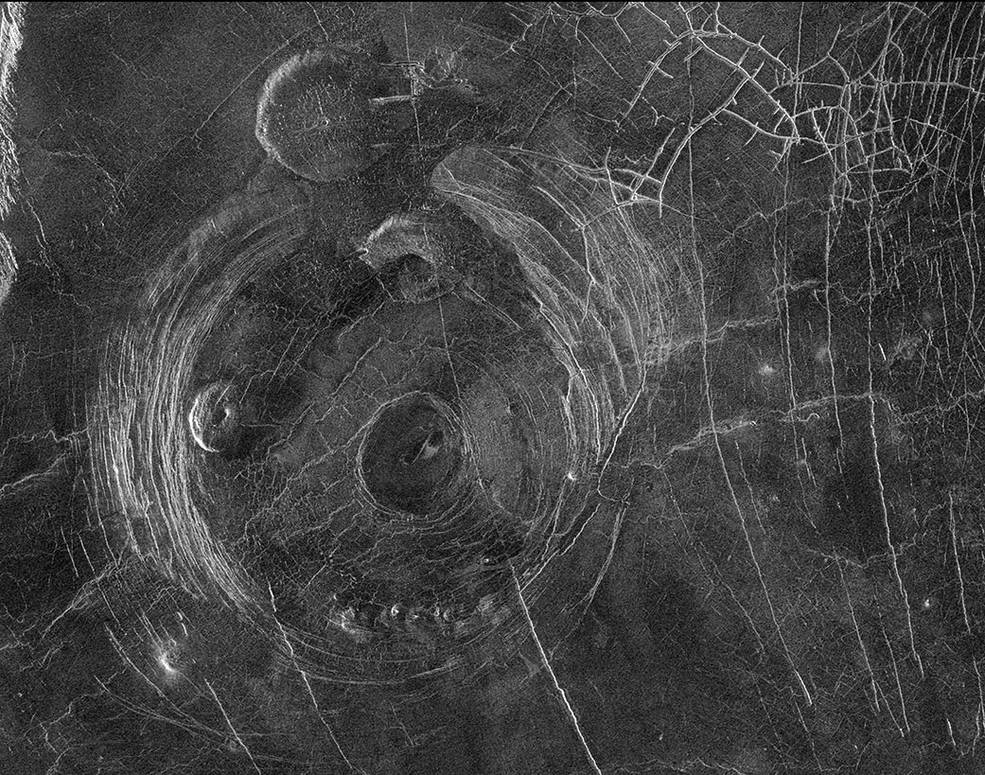 This radar image from NASA’s Magellan mission shows circular fracture patterns surrounding the “Aine” corona