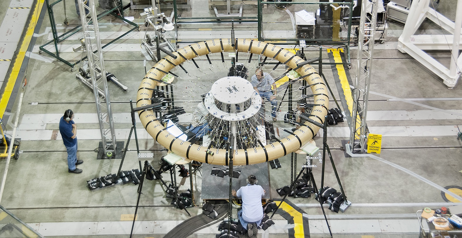 Researchers at NASA’s Armstrong Flight Research Center, Edwards, California, test a component of the Hypersonic Inflatable Aerodynamic Decelerator, or HIAD, in 2013 in the center’s Flight Loads Laboratory.