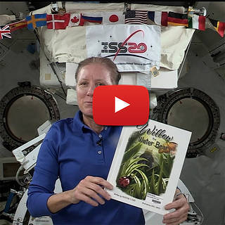 A picture of astronaut holding a book