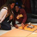 Two students competing in a robotic engineering design challenge