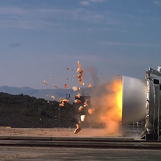 A rocket booster with flames beginning to shoot out